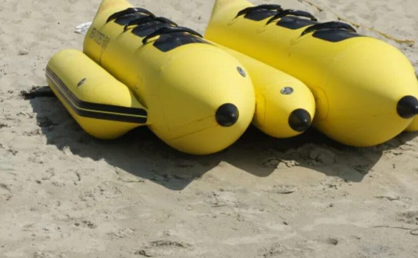 ビーチの砂浜に並べられた黄色い2艇のバナナボート。出航を待つ沖縄のマリンアクティビティ機材。